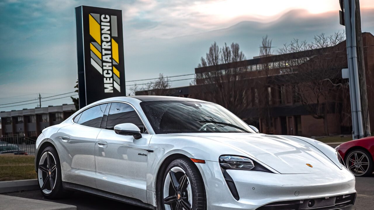 White Porsche Taycan in front of Mechatronic Diagnostics
