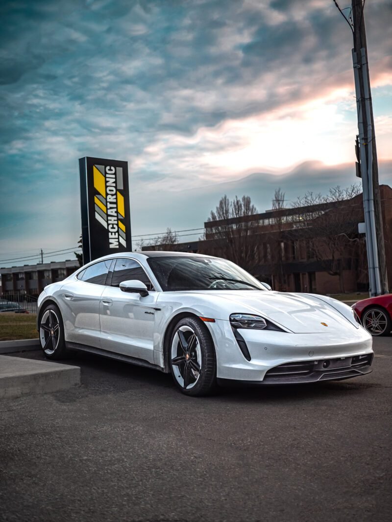 White Porsche Taycan in front of Mechatronic Diagnostics